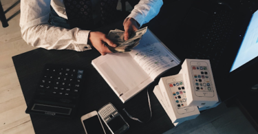 accountant sitting at a desk counting money